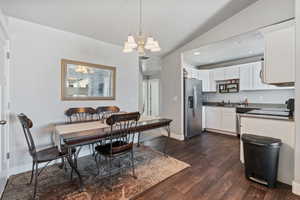 Dining area featuring vaulted ceiling