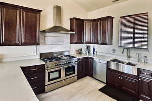 Kitchen featuring lofted ceilings, a wealth of natural light, over-sized fridge/freezer and professional range with dual ovens.