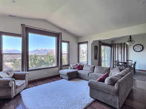 Autumn view- Great room with a mountain view, dark hardwood flooring, and lofted ceiling