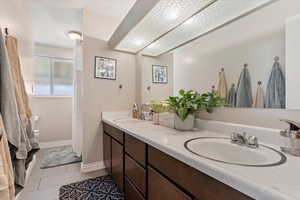 Bathroom featuring tile patterned flooring and vanity