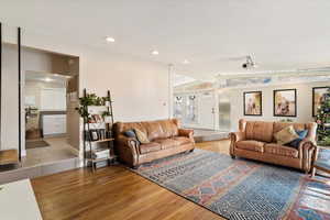 Living room featuring hardwood / wood-style floors and lofted ceiling