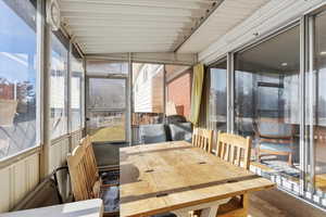 Sunroom featuring lofted ceiling