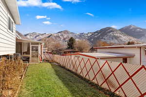 View of yard with a sunroom and a mountain view