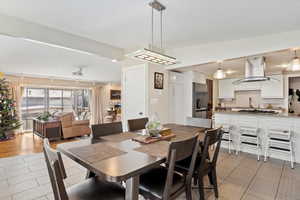 Dining area featuring light tile patterned floors and track lighting