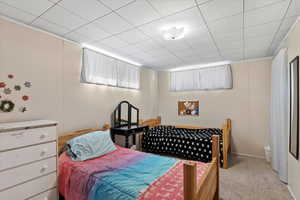 Carpeted bedroom with crown molding