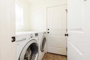 Washroom with laundry area and washer and clothes dryer