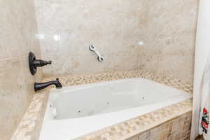 Bathroom featuring tiled tub