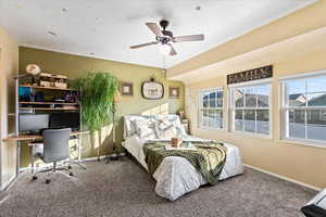 Carpeted bedroom with ceiling fan