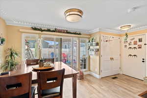 Dining area featuring crown molding and light hardwood / wood-style floors