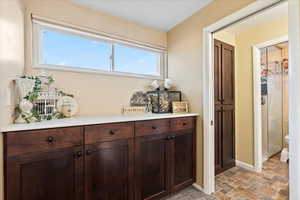 Bar featuring dark brown cabinetry