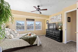 Bedroom featuring ceiling fan and carpet floors