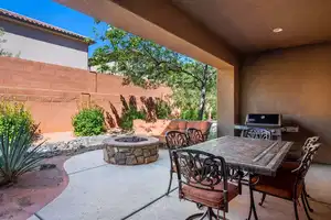 View of patio with a fire pit and grilling area