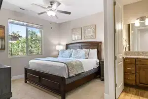 Bedroom with light carpet and ceiling fan