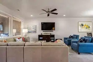 Living room featuring ceiling fan and light colored carpet