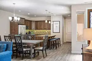 Dining room with light wood-type flooring and an inviting chandelier