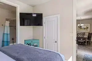 Bedroom with hardwood / wood-style floors, a closet, and an inviting chandelier