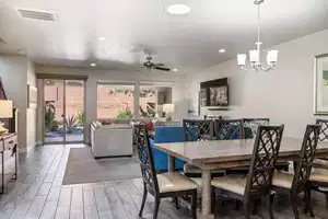 Dining room with ceiling fan with notable chandelier