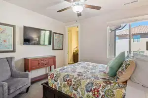 Carpeted bedroom with ceiling fan