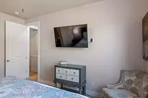 Bedroom featuring light colored carpet