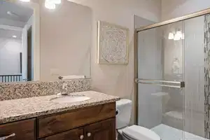 Bathroom with walk in shower, vanity, and toilet