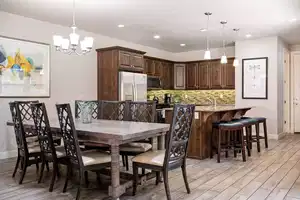 Dining area with light hardwood / wood-style floors and an inviting chandelier