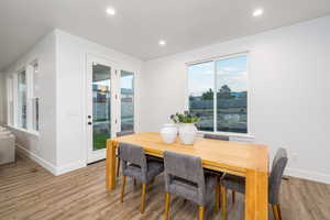 Dining space with light hardwood / wood-style floors