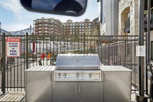 View of patio with area for grilling, a mountain view, and an outdoor kitchen