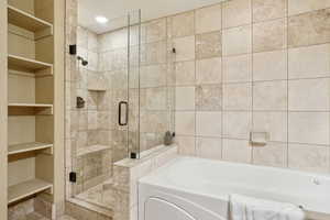 Bathroom featuring separate shower and tub and built in features