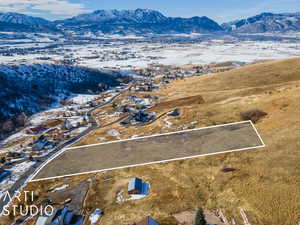 Snowy aerial view featuring a mountain view