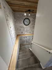 Stairs with wooden ceiling and rail lighting