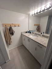 Bathroom featuring vanity and a textured ceiling