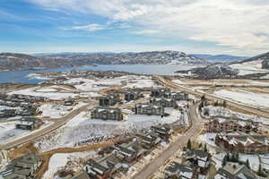 Snowy aerial view featuring a water and mountain view