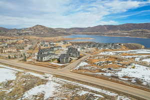 Snowy aerial view with a water and mountain view