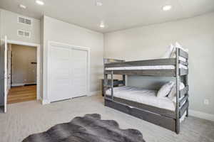 Bedroom featuring light hardwood / wood-style floors and a closet