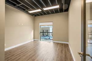 Unfurnished room with hardwood / wood-style flooring