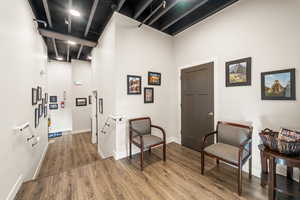 Living area featuring a towering ceiling and hardwood / wood-style flooring