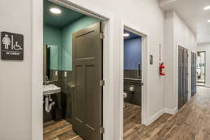 Hall featuring sink and dark wood-type flooring