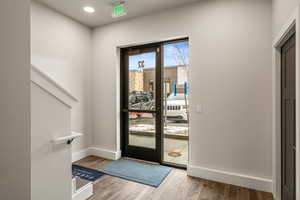 Doorway to outside featuring wood-type flooring