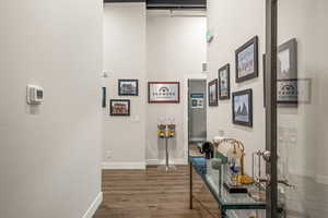 Corridor with dark hardwood / wood-style flooring