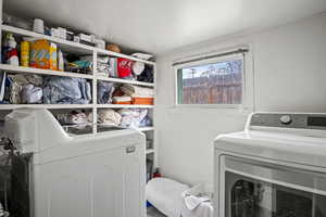 Washroom featuring washer and dryer