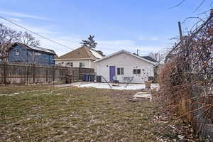 Back of property with a yard and a patio area