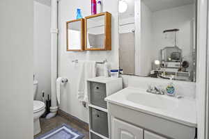 Bathroom with vanity, tile patterned floors, and toilet