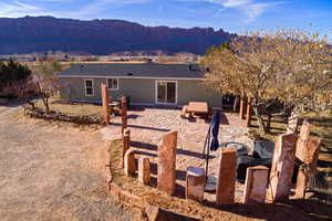 Rear view of property with a mountain view and a patio area