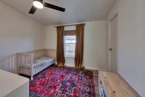 Bedroom featuring hardwood / wood-style flooring and ceiling fan