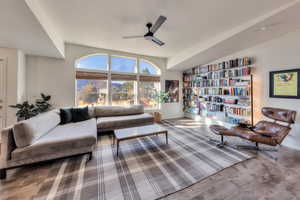 Living room with hardwood / wood-style floors and ceiling fan