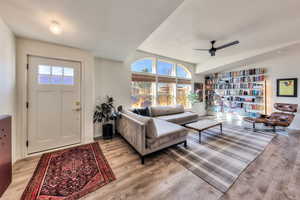 Entrance foyer featuring ceiling fan, light wood-type flooring, and lofted ceiling