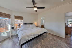 Bedroom with ceiling fan and hardwood / wood-style flooring