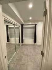 Hall featuring light tile patterned flooring