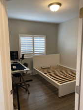 Bedroom with dark wood-type flooring