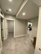 Hall featuring light tile patterned floors